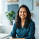 A smiling South Asian woman looking confident and happy, representing a satisfied customer for ZappyCo.